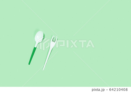 Plastic spoons on blue background. 64210408