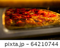 Pizza baked in an electric oven close-up 64210744