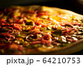 Pizza baked in an electric oven close-up 64210753