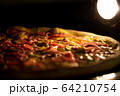 Pizza baked in an electric oven close-up 64210754