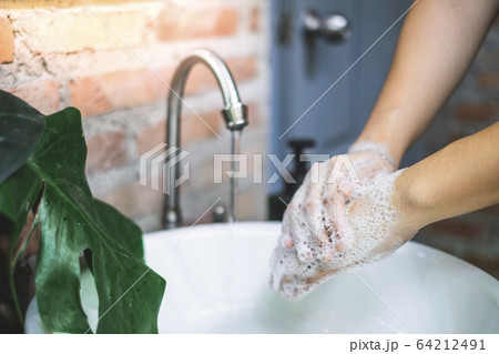 Lather the backs of your hands by rubbing them Lather the backs of your hands by rubbing them 64212491