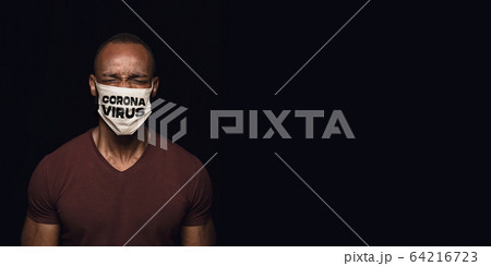 Man in protective mask with word CORONAVIRUS, coronavirus prevention, protection concept, flyer Man in protective mask with word CORONAVIRUS, coronavirus prevention, protection concept, flyer 64216723