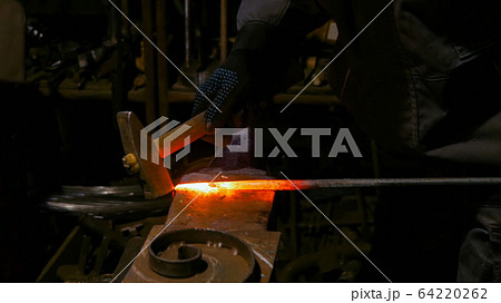 Blacksmith working with metal Blacksmith working with metal 64220262