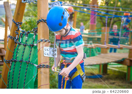 Little cute boy enjoying activity in a climbing 64220660