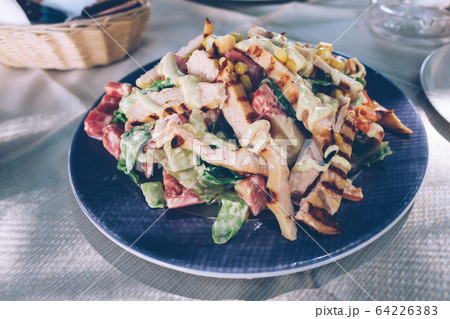Greek salad with grilled chicken on plate Greek salad with grilled chicken on plate 64226383