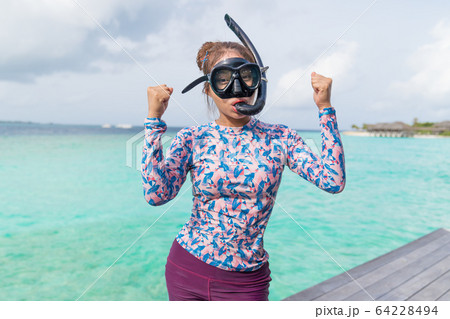 Asian beautiful woman is snorkeling in the lagoon Asian beautiful woman is snorkeling in the lagoon 64228494