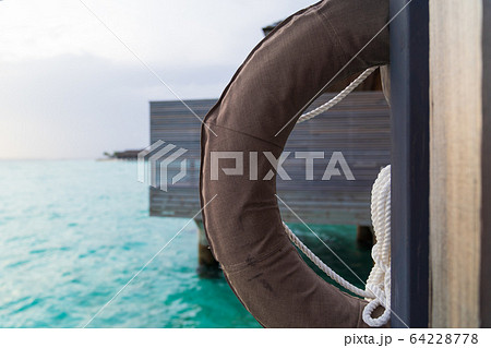 Life ring in luxury resport background. Life ring in luxury resport background. 64228778