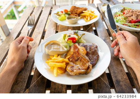 First-person view of a guy eating food in a summer First-person view of a guy eating food in a summer 64233984