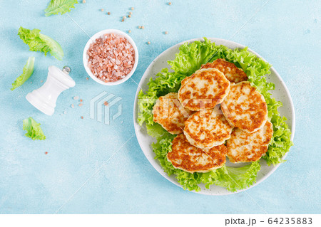 Chicken cutlets with fresh lettuce salad on plate Chicken cutlets with fresh lettuce salad on plate 64235883