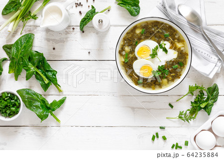 Green sorrel and spinach soup with boiled egg and 64235884
