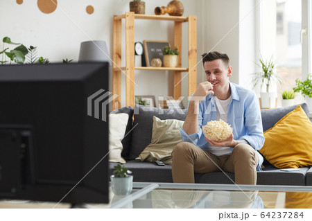 Man sitting at home 64237284