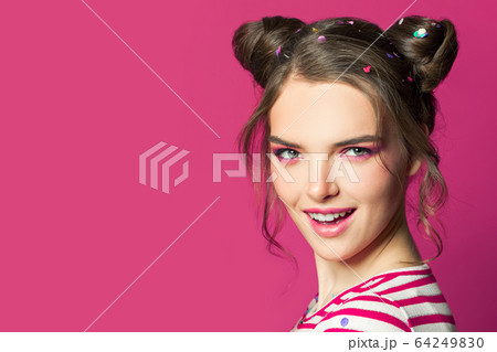 Happy woman with fashion makeup on bright pink 64249830