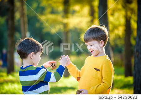 Two Cute sibling little boy playing together with 64250033