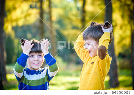 Two Cute sibling little boy playing together with 64250035