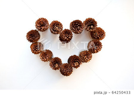 Pine cones heart shaped composition isolated on white background 64250433