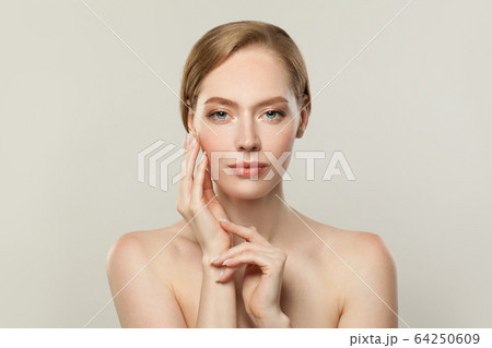 Young perfect woman with clear skin. Skincare  64250609