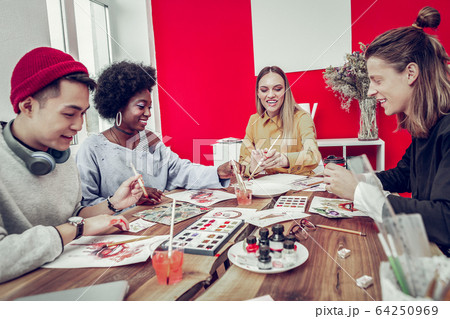 Happy mixed raced people visiting art workshop 64250969