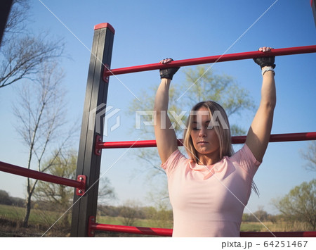 Woman Exercising in the Park 64251467