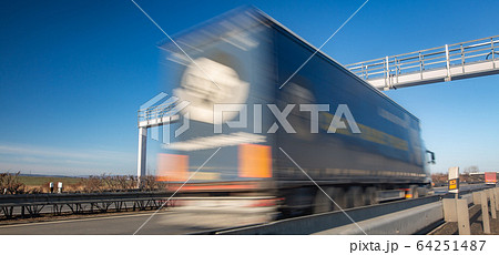 Truck passing through a toll gate on a highway, highway charges, motion blurred image Truck passing through a toll gate on a highway, highway charges, motion blurred image 64251487
