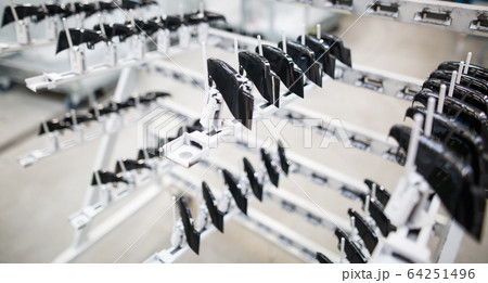 Freshly molded plastic moldings in automotive smart factory, industrial concept 64251496