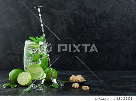 Glass of Mojito cocktail with ice cubes mint and 64253131