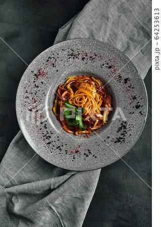 Spaghetti with vegetables tomato sauce and meat. Traditional italian food. Food photo. Dish from the chef. Beautiful feed, close-up shot, top view, copy space 64253613