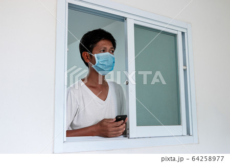 Man in isolation at home for coronavirus outbreak 64258977