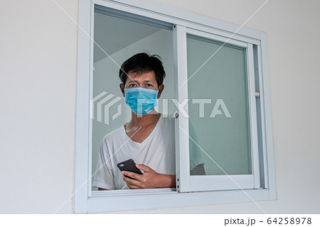 Man in isolation at home for coronavirus outbreak 64258978