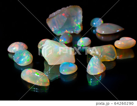Composition of precious opal jewels. Cuts and rough material Composition of precious opal jewels. Cuts and rough material 64260290