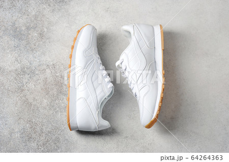 pair of white athletic sneakers pair of white athletic sneakers 64264363