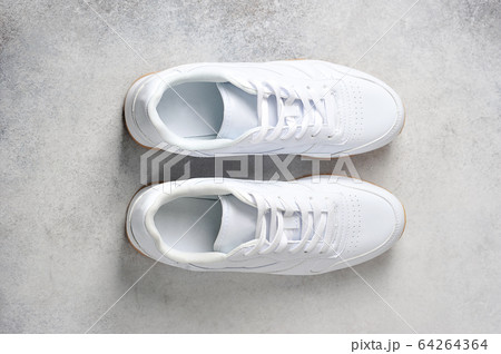 pair of white athletic sneakers 64264364
