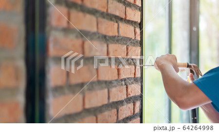 Close up hand of asian man holding hammer with Close up hand of asian man holding hammer with 64264998