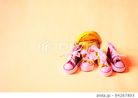 Sneakers and backpack isolated on color background Sneakers and backpack isolated on color background 64267803