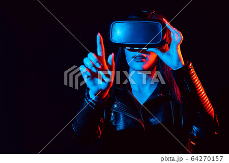 girl in modern virtual reality glasses on a black background girl in modern virtual reality glasses on a black background 64270157
