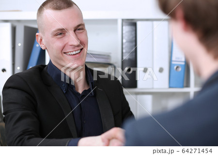Smiling businessman shake hands as hello in office 64271454
