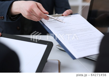 Male arm in suit offer contract form on clipboard pad 64271456