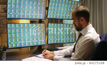 Businessman in suits looking at graphs 64275108