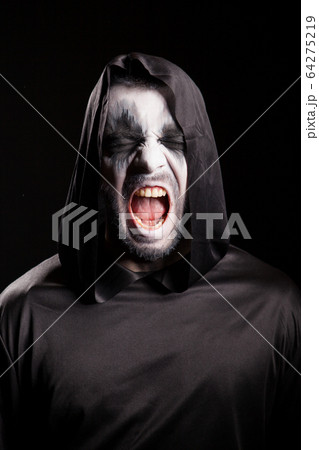 Portrait of grim reaper screaming over black background Portrait of grim reaper screaming over black background 64275219