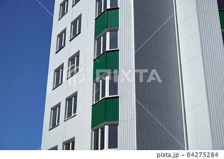 facade of a new multistory building with white and 64275284