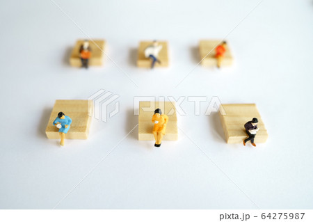 Social distancing. Miniature people stay apart to 64275987