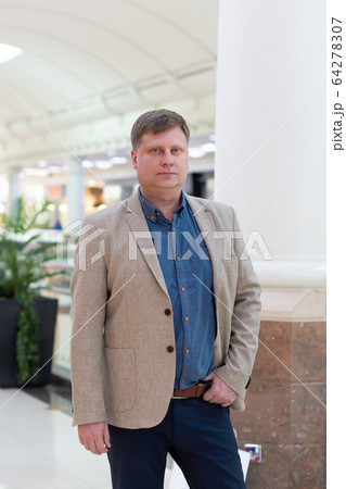 Fashion man model in a light business suit. Fashion man model in a light business suit. 64278307
