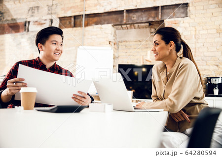Joyful office workers are discussing new project 64280594