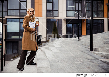 Elegant Caucasian female smiling at the camera 64282903