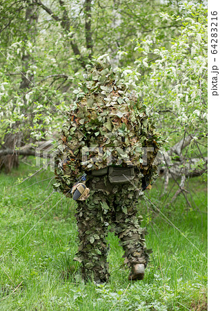 Camouflaged Hunter In Jungle Like Area With Sniper Rifle , He Must Blend  Into Surrounding To Not Be Detected Stock Photo, Picture and Royalty Free  Image. Image 67250301.