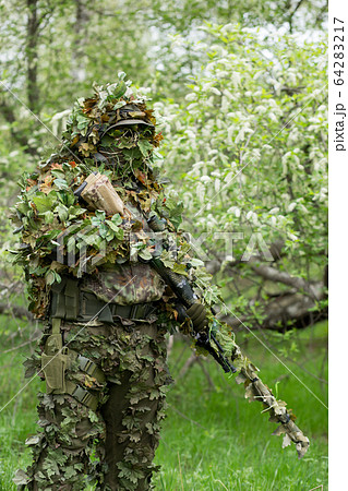 Camouflaged Hunter In Jungle Like Area With Sniper Rifle , He Must Blend  Into Surrounding To Not Be Detected Stock Photo, Picture and Royalty Free  Image. Image 67250301.