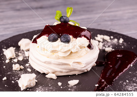 Dessert Pavlova with gentle cream, whipped cream, served with berries and jam 64284555