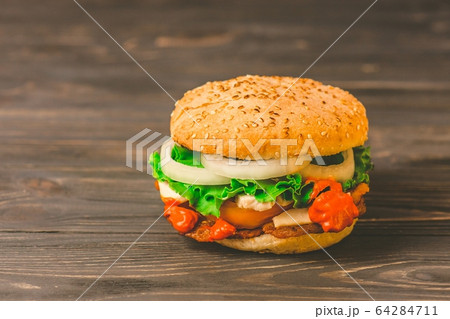 Homemade burger on dark rustic wooden background Homemade burger on dark rustic wooden background 64284711
