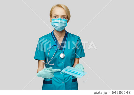 medical doctor nurse woman with stethoscope over light grey background - showing protective mask medical doctor nurse woman with stethoscope over light grey background - showing protective mask 64286548