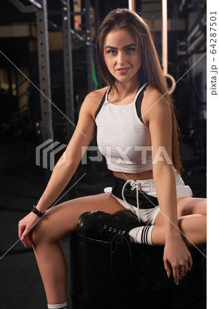 Young girl on training apparatus in a gym shot Young girl on training apparatus in a gym shot 64287501