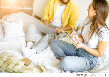 young couple preparing invitations for wedding at home 64288291